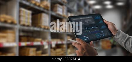 Logistics manager analyzing supply chain data dashboard on tablet inside warehouse storage facility. Concept of logistics analytics, inventory monitor Stock Photo
