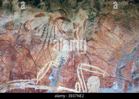 Aboriginal rock art depicts figures of Mimi Spirits on a cave wall ...