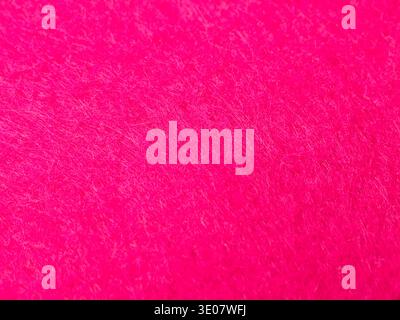 A high-resolution, full-frame texture of vibrant hot pink or magenta felt fabric. Stock Photo