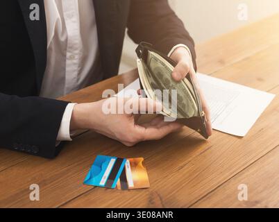 Man's hands holding open wallet with money Stock Photo