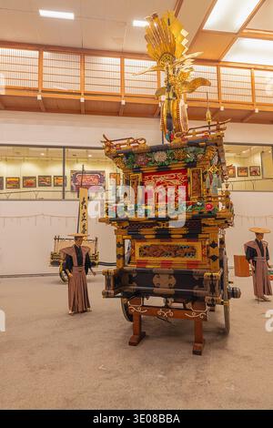 Editorial: TAKAYAMA, HONSHU, JAPAN, September 9, 2025 - Heavily gilded decorated float with marionettes in the background from the Takayama festival, Stock Photo