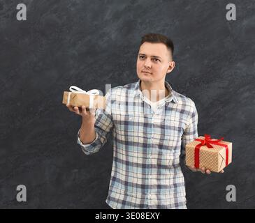 Curious man trying to guess present Stock Photo