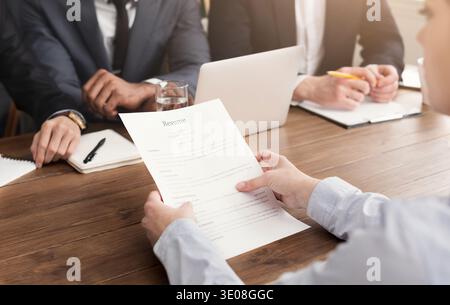 Female candidate holding resume during interview Stock Photo