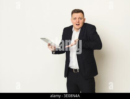 Disappointed caucasian businessman using laptop Stock Photo