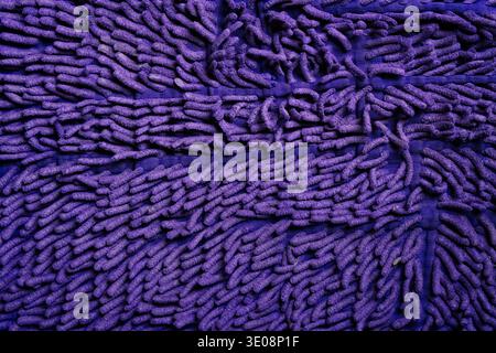 Vibrant purple chenille microfiber rug texture for modern branding, digital aesthetic backgrounds, and bold tactile textile design Stock Photo
