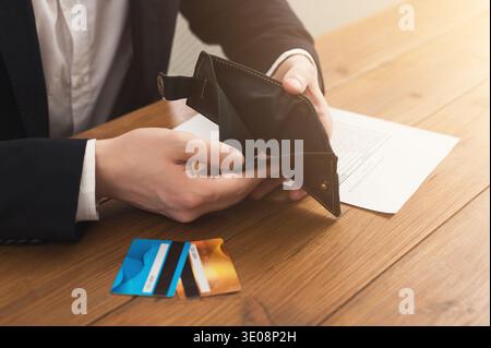 Man's hands holding open empty wallet Stock Photo