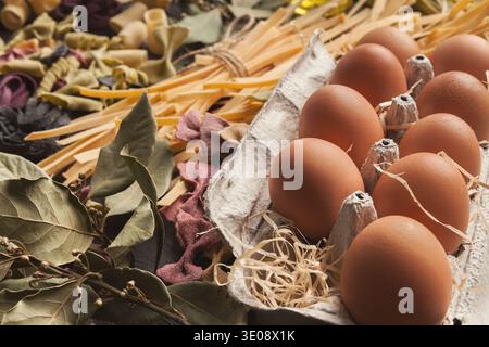 Mixed italian pasta and vegetables on dark wood Stock Photo