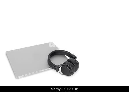 Black wireless headphones with laptop on white background Stock Photo