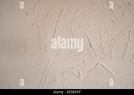 Rugged effect plaster beige color cement wall textured background Stock Photo