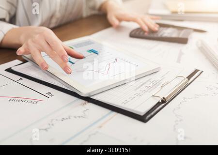 Calculator and financial charts on workplace Stock Photo
