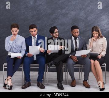 Multiethnic job candidates preparing for job interview Stock Photo