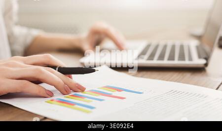 Woman using laptop with graph money stock trading Stock Photo
