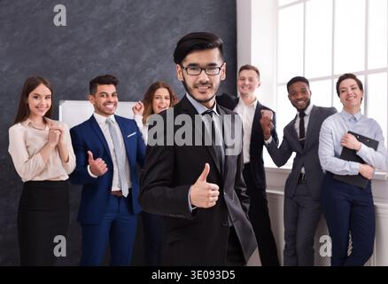 Group of People Celebrating Success in a Business Setting With Smiles and Positive Gestures Stock Photo