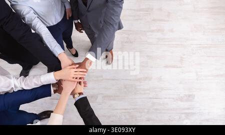 Business people put hands together on white background Stock Photo