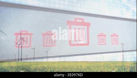 Displaying red trash-bin icons floating on translucent panel above yellow crop field, wind turbines Stock Photo