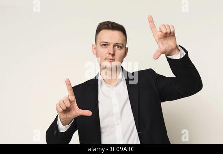 Young businessman using virtual screen for work Stock Photo