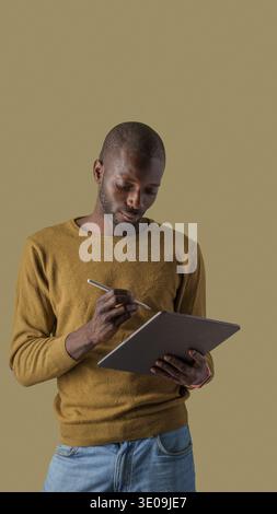 African professional using a digital tablet and stylus while concentrating on work or study. Concept of productivity, digital technology, remote work, Stock Photo