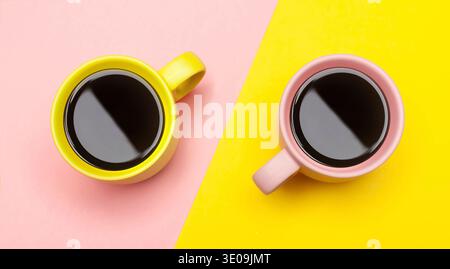 Flat lay top view of a two coffee cups with pink and yellow. Stock Photo