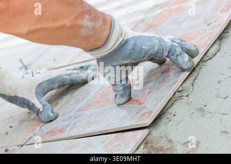 Close up of placing the floor tiles Stock Photo