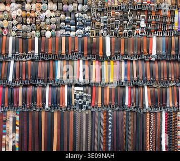 Many colored leather belts on a market. Stock Photo