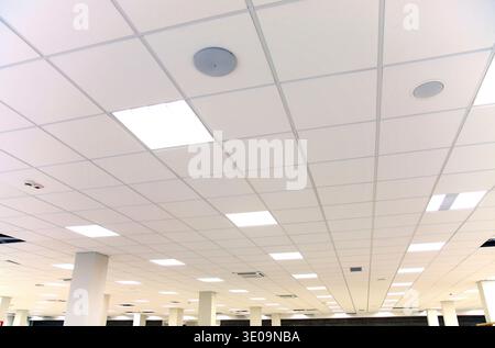 Modern design white office ceiling with white tiles and lighting Stock Photo