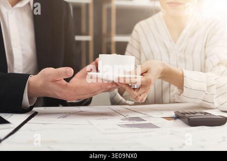 Woman hands giving cup of coffee to businessman Stock Photo