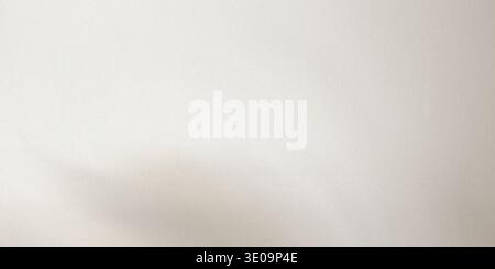 A subtle gray shadow on a beige textured surface with gentle curves and soft gradient effect Stock Photo