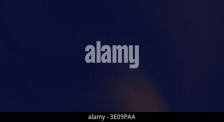 A dark blue gradient background with an orange tone, featuring a smooth transition of colors that creates a sense of depth and visual appeal. Stock Photo