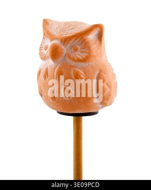Isolated owl in clay on wooden stick Stock Photo
