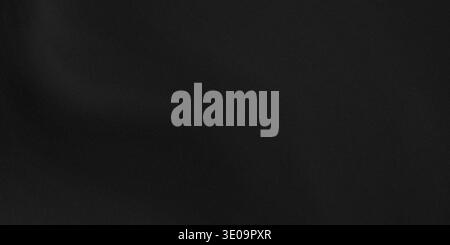 A close-up shot of a deep black, finely textured surface. The image is rich in dark tones with subtle variations in texture, providing a dramatic and Stock Photo