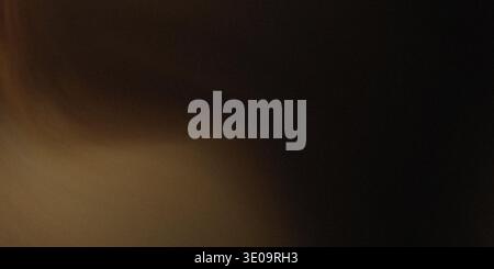 A dark brown gradient background with a shadowy, smooth transition from light to dark, no distinct features Stock Photo