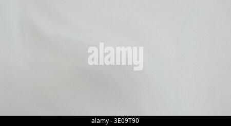 Light gray fabric with a subtle sheen and smooth surface, showcasing a detailed texture with fine threads and gentle folds Stock Photo
