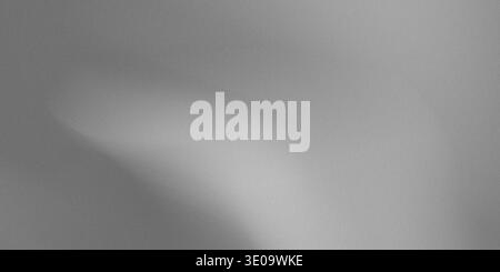 A close-up view of a gray fabric with a light shadow, showcasing a smooth gradient and a soft, even texture. The fabric appears to be made of a high-q Stock Photo