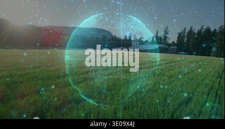 Projecting holographic turquoise globe hovering over rural meadow near farmhouse, showing sun flare Stock Photo