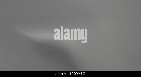 A gray background with a smooth texture and a lighter gray shadow on the top left corner, creating a sense of subtle contrast and visual interest. Stock Photo