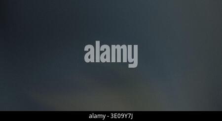 An abstract image displaying a dark, muted slate blue or deep gray color with a noticeable fine texture or grain. There is a very subtle variation in Stock Photo