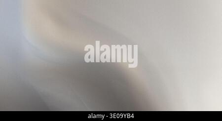 This image displays a close-up of a gray fabric with visible folds and creases on its surface. The fabric appears to have a smooth texture, with sever Stock Photo