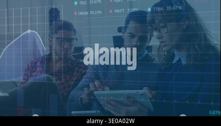 Analyzing overlaid charts, team of three holding tablet and laptop in plaid, knit tops at workspace Stock Photo