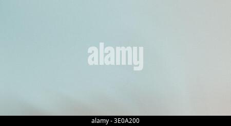 A pale blue and gray gradient background with a soft texture, featuring a subtle transition between colors, perfect for use as a background or overlay Stock Photo