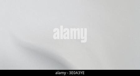 This image showcases a detailed view of a light gray fabric, highlighting its smooth texture and soft folds. The fabric appears to have a subtle sheen Stock Photo