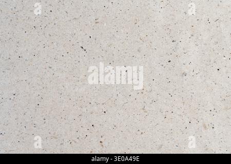 Minimalist light beige kraft paper texture background with fine dark dots pattern and copy space Stock Photo
