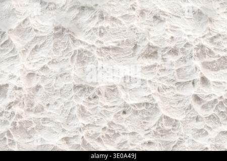 Abstract white textured plaster background with wavy decorative stucco relief and copy space Stock Photo
