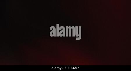 This image showcases a gradient background transitioning from dark red to black, creating a dramatic and intense visual effect. Stock Photo
