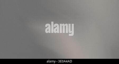 A gray surface with a light reflection casting a shadow on it, creating a sense of contrast and visual interest, with a smooth and slightly shiny comp Stock Photo