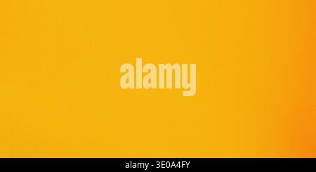 The image features a vibrant orange gradient background with no distinct objects or features present, showcasing a smooth transition of orange hues Stock Photo