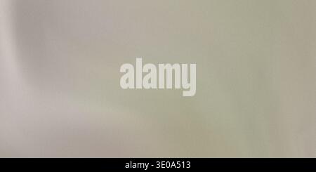 This image features a detailed view of a light green fabric with a smooth texture and gentle folds, showcasing its natural material and subtle sheen i Stock Photo