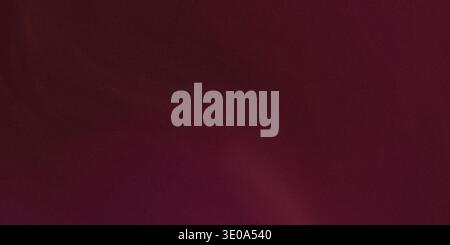 An abstract image showcasing a rich, deep burgundy or maroon color with a noticeable grainy texture. The lighting creates subtle variations in shade a Stock Photo