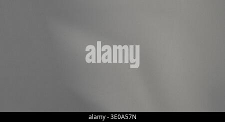 This image captures a light gray, finely textured material, possibly fabric, showing gentle, organic folds and subtle variations in shading due to sof Stock Photo