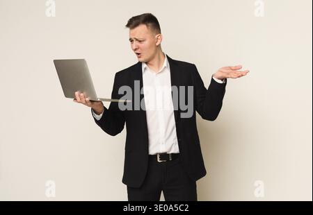 Disappointed caucasian businessman using laptop Stock Photo