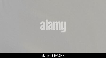 A detailed view of a light gray, finely textured surface, resembling woven fabric or fine paper. The neutral color provides excellent contrast and is Stock Photo